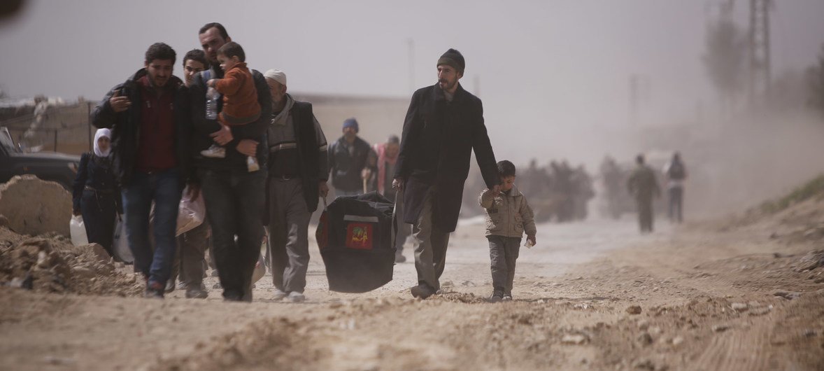 On 15 March 2018 in Beit Sawa, eastern Ghouta. families walk towards Hamourieh where an evacuation exit from Eastern Ghouta has been opened.