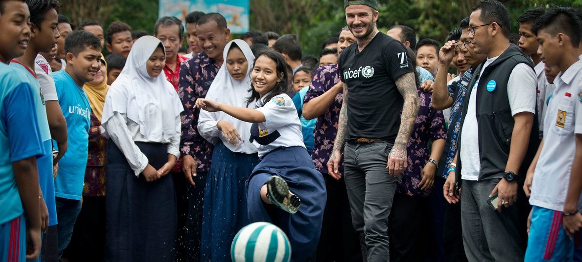 UNICEF Goodwill Ambassador David Beckham plays soccers with students and teachers at the SMPN 17 school in Semarang, Indonesia.