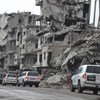 In this file photo, a convoy of UN humanitarian vehicles moves through the war-ravaged city of Homs. While aid access has improved in parts of Syria, millions of civilians remain dependent on cross-border deliveries of food and other aid.