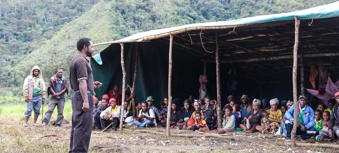 People affected by the earthquake in Papua New Guinea take shelter under a tent. Across the island nation, over 270,000 remain dependent on humanitarian assistance in the aftermath of the disaster and a series of devastating aftershocks.