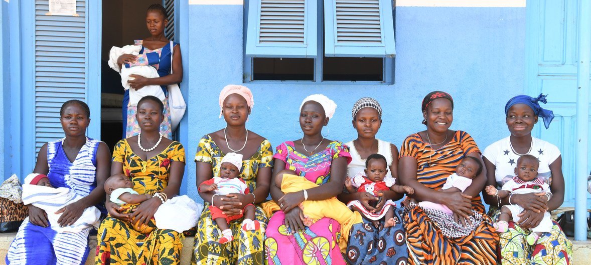 Women along with their new-born children wait to see doctors at a local hospital in north-east Côte d'Ivoire. The infants are to be vaccinated against a number of diseases, including Yellow Fever. In addition, families will be provided with mosquito nets,