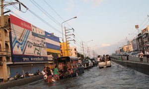Panic-stricken residents of a suburb of the Thai capital, Bangkok, climbing aboard cars and trucks to evacuate the area.