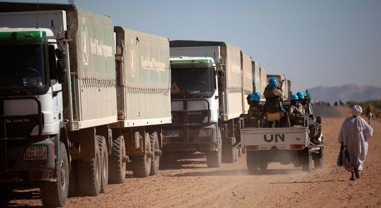 UNAMID troops from Ethiopia and Rwanda escort World Food Programme (WFP) trucks during a trip from El Fasher to Shangil Tobaya, in North Darfur, in February 2014. The journey, nearly 100 kilometres, took more than 8 hours due to difficult road conditions.