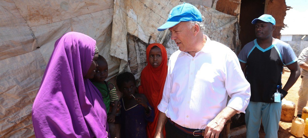 The UN Secretary-General's Special Representative for Somalia, Michael Keating interacts with refugees outside their houses at the IFO camp in Dadaab, located in Kenya, on 12 April 2018.