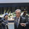 UN Secretary-General António Guterres, centre, lights a candle at an annual memorial service for fallen UN staff. 