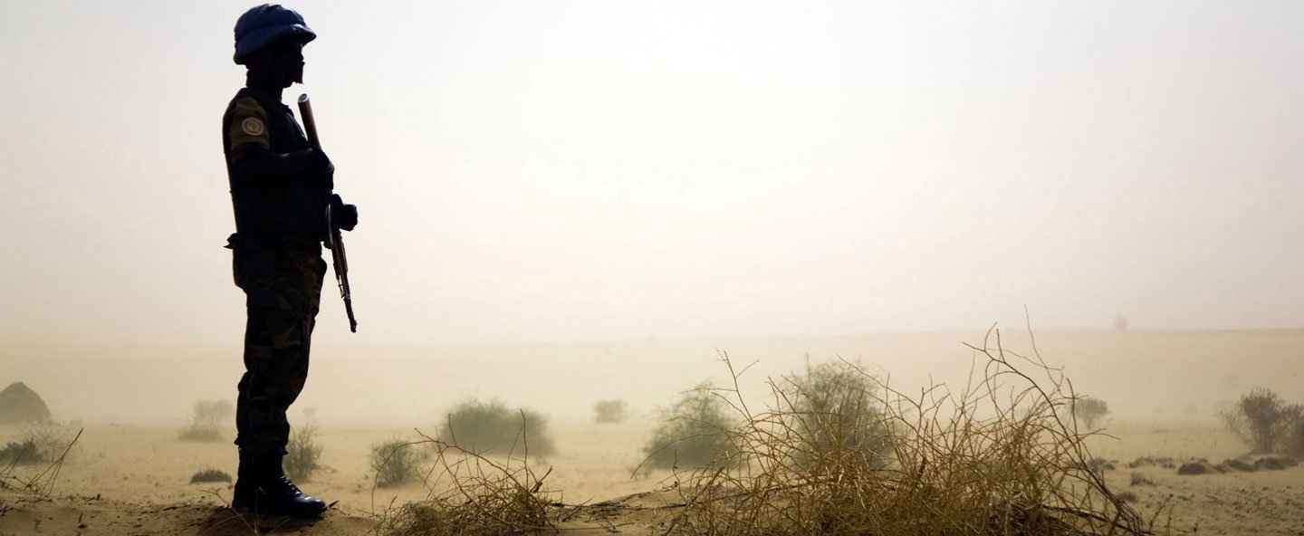 A Rwandan peacekeeper serving with the mission in Darfur (UNAMID) is seen here during a mission to deliver water to the village of Tora in in April 2010.