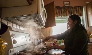 An indigenous woman from Otavalo, in Ecuador, cooks at home.