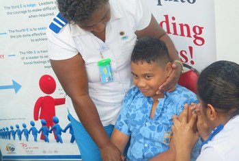 A 5 year old boy receives a vaccination shot during the launch of the Meningococcal C Vaccination Campaign in Fiji.