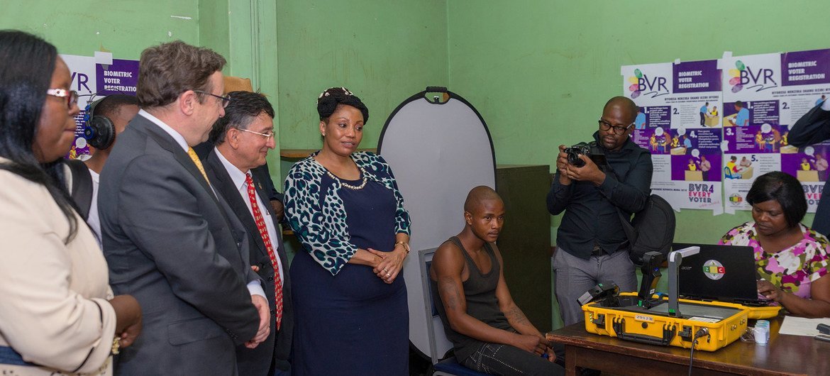 UNDP’s Administrator Achim Steiner (2nd from left) and Bishow Parajuli (3rd from left) witnessed a 19-year-old register to vote for the first time using the new technology, Biometric Voter Registration, at the Mbare registration center in Harare, Zimbabwe