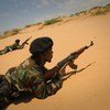 In this file photo, a Somali National Army (SNA) soldier takes up a defensive position during a live-fire exercise as part of a passing-out ceremony marking the conclusion of an advanced training course.