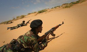 In this file photo, a Somali National Army (SNA) soldier takes up a defensive position during a live-fire exercise as part of a passing-out ceremony marking the conclusion of an advanced training course.
