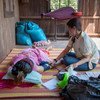 Nhek Chande, a secondary midwife at a local health centre in rural Cambodia conducts a prenatal check-up for a pregnant woman. Midwives play an important role in the communities, helping mothers, and expectant-mothers, make informed, healthy choices.