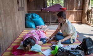 Nhek Chande, a secondary midwife at a local health centre in rural Cambodia conducts a prenatal check-up for a pregnant woman. Midwives play an important role in the communities, helping mothers, and expectant-mothers, make informed, healthy choices.