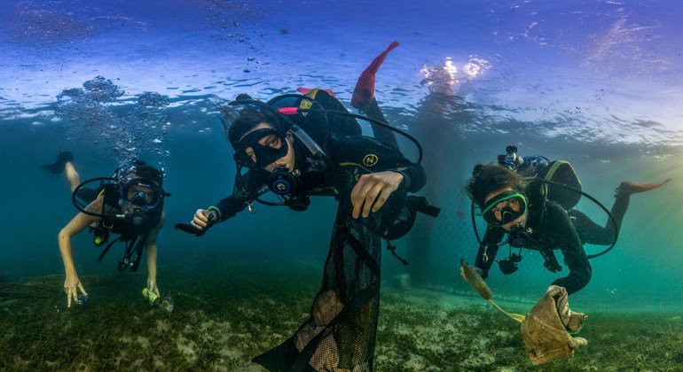 Underwater photographers have drawn attention to the dangers of plastic pollution in oceans around the world as part of a completion to highlight World Oceans Day.