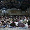 Des migrants sont couchés sur des matelas à l'intérieur d'un centre de détention, situé en Libye. (archive)