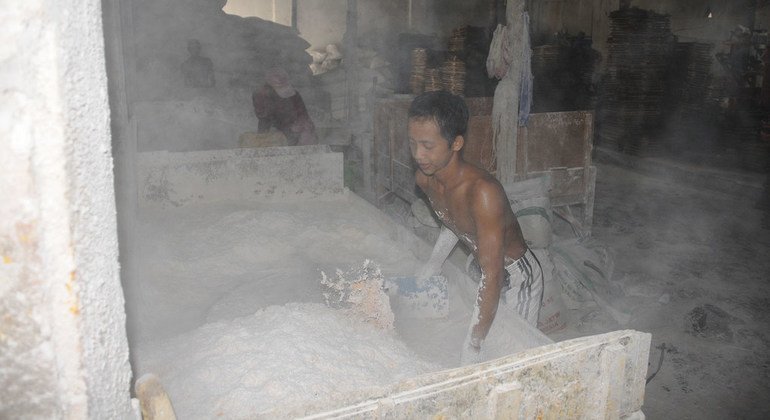 Children work at the food production, producing Indonesian traditional chips, in Sidoarjo, East Java, Indonesia.