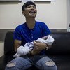 A man cries with laughter as he holds his newborn baby, born a few moments before at Lerdsin Hospital, Bangkok, Thailand.