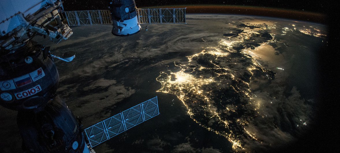 Снимок ночной Земли, сделанный с Международной космической станции в момент полета над Японией. Слева на фото - космический корабль "Союз", пристыкованный к малому исследовательскому модулю "Рассвет"