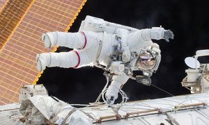 NASA astronaut Scott Kelly is seen floating during a spacewalk on 21  December 2015 as he and fellow astronaut Tim Kopra released brake handles on crew equipment carts on either side of the space station.