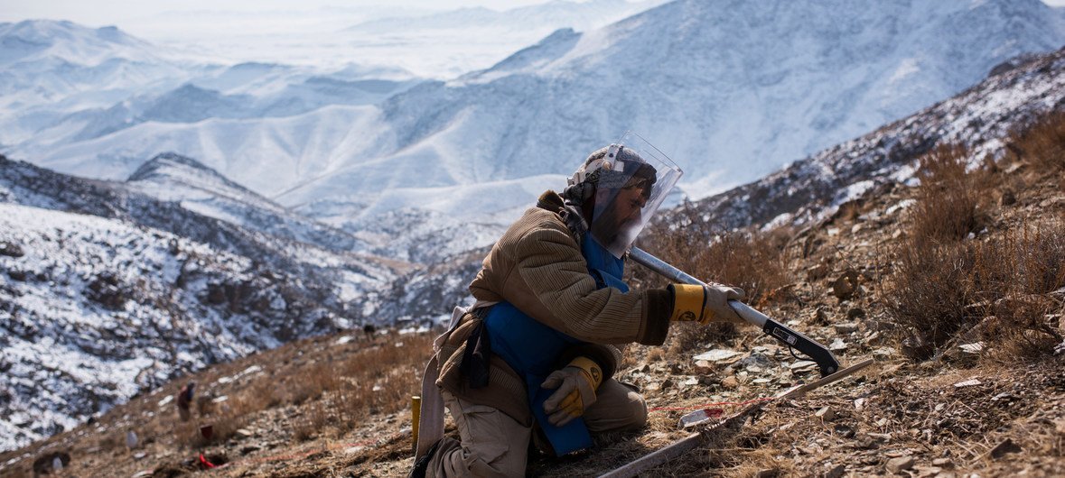 An explosives specialist conducts mine clearance operations after detecting a piece of metal in the mountains near Kabul, Afghanistan.