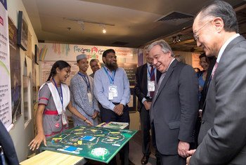 Secretário-geral António Guterres e o presidente do Grupo Banco Mundial, Jim Yong Kim, falam com crianças em uma exposição em Daca.