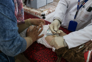 Doctors administer a polio vaccine to a 2-year-old boy at the Al-Quds Primary Health Care Center (PHCC) in West Mosul, Iraq, which found itself operating far beyond usual capacity — without the full resources of a hospital — months after military operatio