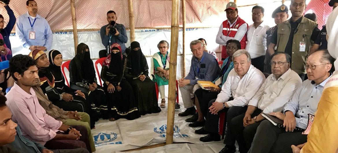 2018年7月2日，联合国秘书长古特雷斯（右三），世界银行行长金墉（右一），联合国人口基金执行主任纳塔莉亚•卡内姆博士（右四）和难民专员办事处高级专员菲利波•格兰迪（右五）在孟加拉国考克斯巴扎地区的难民营中与罗兴亚难民交谈。