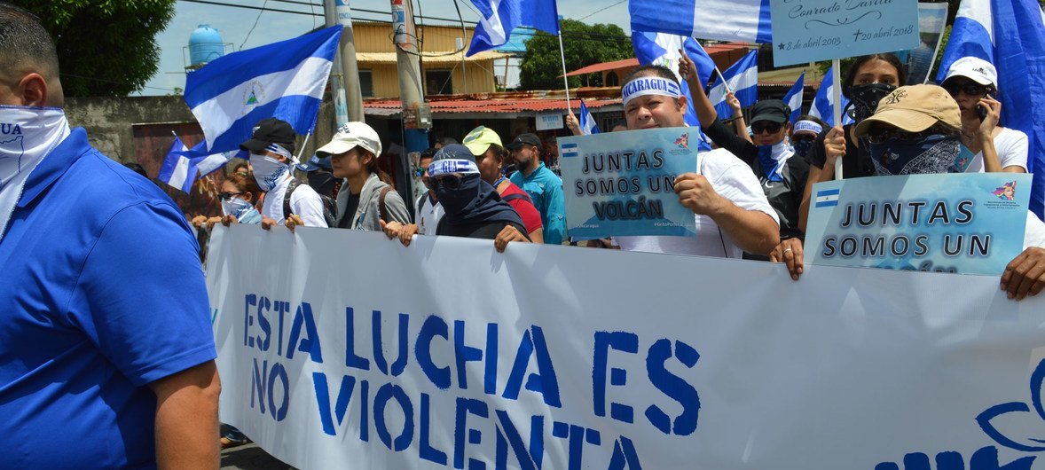Protesters in Managua take part in a march to demand an end to violence in Nicaragua. The banner reads "This struggle is non-violent" in Spanish.