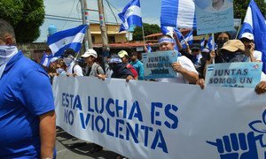 Protesters in Managua take part in a march to demand an end to violence in Nicaragua. The banner reads "This struggle is non-violent" in Spanish.