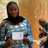 Ahead of Mali's 2018 presidential elections, this young women is picking up her new voter's card at an electoral station in Gao, in the country's north.