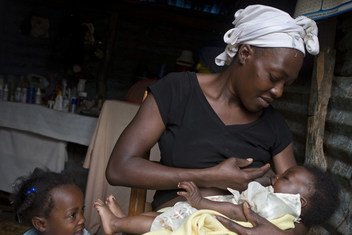26 year old Masita Lemorin breast feeds her 4 month old son Nathanael as her daughter Anne watches at her house in Quicroit, an isolated village on the mountains south of Port au Prince, Haiti.