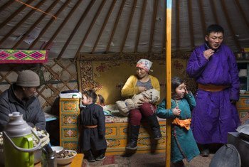 Thirty-two year old Delgermurun breastfeeds her eight-day-old baby amidst her family in a ger, Alag-Erdene, Mongolia. 