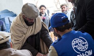 IOM staff register beneficiaries during a distribution for natural disaster-affected families in Afghanistan. March 2015.