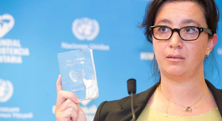 Elpida Rouka, Senior Political Officer, Office of the Special Envoy for Syria and survivor of the bombing of the Canal Hotel in Baghdad on 19 August 2003 shows her UN Laisser Passer during the Solemn Commemoration Ceremony of the World Humanitarian Day, P