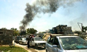 Members of the ethnic minority Tawergha community leave their makeshift homes in Tripoli, Libya, after the houses were demolished by a local militia. 