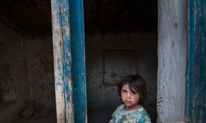 A young girl looks through a paneless window frame near Kabul, in Afghanistan, 2013. Civlilians in Afghanistan have borne the brunt of an almost 20 years of conflict.