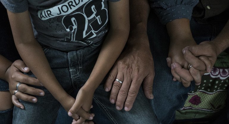Pilar de 15 años sentada junto a su familia en Guatemala después de que su familia escapara de Honduras de las pandillas, que querían obligarla a convertirse en prostituta.