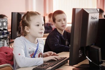 Nine-year-old Masha (left), a refugee from Ukraine, designs computer games at a programming class in Minsk, Belarus, part of the eKIDS programme, an innovative tech project sponsored by UNHCR and EPAM Systems.