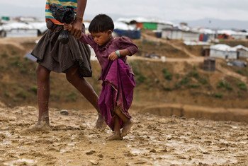 Two-year-old Rumana is led by a community worker as she and her family are relocated to a safer area of the Kutupalong-Balukhali camp, part of the refugee camp sheltering over 800,000 Rohingya refugees, Cox's Bazar, Bangladesh.