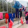 A woman hangs washing out to dry at the Vathy Reception and Identification Centre (RIC) on the island of Samos, Greece.   Refugee families are struggling at the reception centres on the island of Samos due to overcrowding, leading to deteriorating conditions.