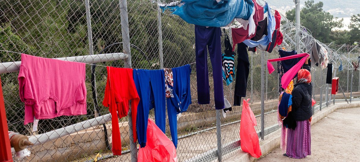 A woman hangs washing out to dry at the Vathy Reception and Identification Centre (RIC) on the island of Samos, Greece.   Refugee families are struggling at the reception centres on the island of Samos due to overcrowding, leading to deteriorating conditions.