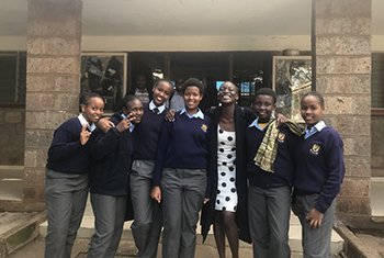 Kenyan singer and suicide prevention advocate Sheilla Akwara with students from Serare Primary School, Kenya, April 2018.