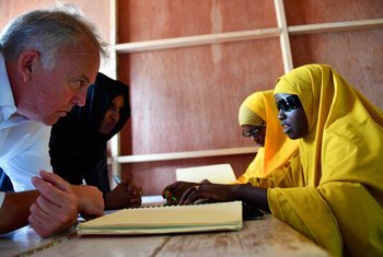 The UN Secretary-General's Special Representative for Somalia, Michael Keating, interacts with blind students during his visit to the Al-Noor School for the Blind in Mogadishu, Somalia, on 9 September 2018.