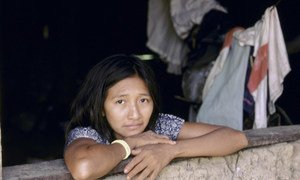 Indigenous woman looks out of window. Brazil.