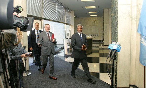 Secretary-General Kofi Annan, approaches a press stakeout at the UN Headquarters, in New York. At his left is Fred Eckhard, his spokesperson.