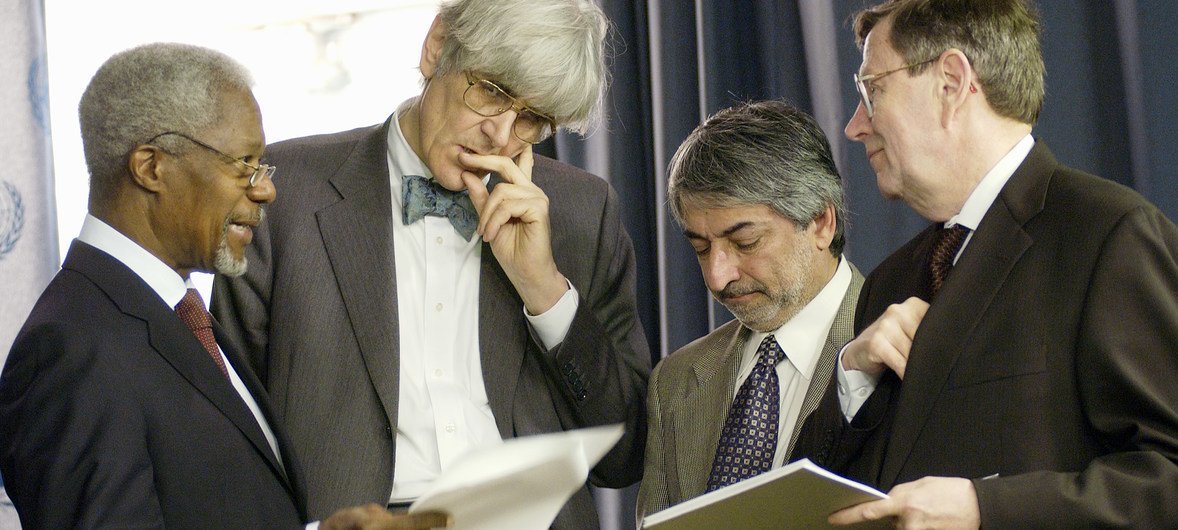 Left to right: Secretary-General Kofi Annan goes over a speech on Iraq with Edward Mortimer, Director of Communications and Head of Speechwriting Unit; Salim Lone, Director of the News and Media Division, Department of Public Information; and Fred Eckhard