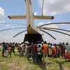 Local volunteers unload the supplies from the back of the helicopter of a UNICEF Rapid Response Mission (RRM) in New Fangkak, South Sudan on 21 July 2018.  The supplies include tetanus vaccine and polio drops, plumpy nut, child protection items, education