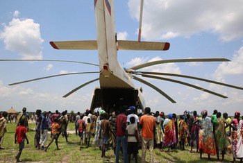 Local volunteers unload the supplies from the back of the helicopter of a UNICEF Rapid Response Mission (RRM) in New Fangkak, South Sudan on 21 July 2018.  The supplies include tetanus vaccine and polio drops, plumpy nut, child protection items, education