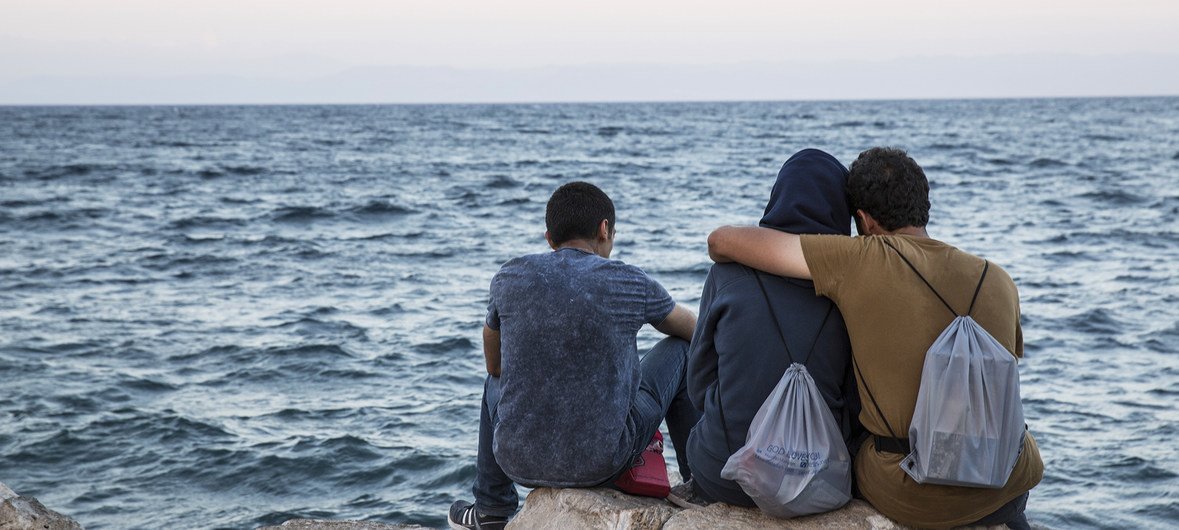 Migrants look out to sea in Lesvos, Greece (file).