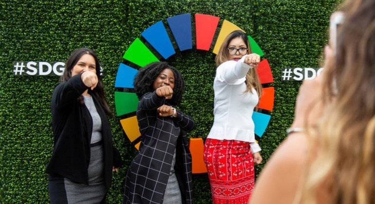 Participant of events held on the first day of the high-level week of the seventy-third session of the General Assembly pose in front of the Sustainable Development Goals emblem. 24 September 2018.